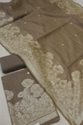 Brown fabric with floral lace detailing on a white background