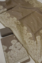 Brown fabric with floral lace detailing on a white background